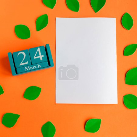 March 24. blue cube calendar and white mockup blank on bright orange background