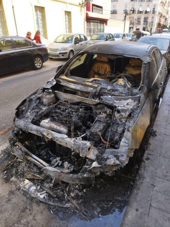 Foto de Una foto vertical de un coche con una campana completamente quemada y parabrisas desaparecido - Imagen libre de derechos