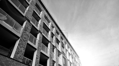 Téléchargez les photos : Apartments in residential complex. Housing structure at modern house.  Architecture for property investment. and architecture details. Urban abstract - windows of apartment building. Black and white. - en image libre de droit