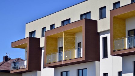  Modern apartment buildings on a sunny day with a blue sky. Facade of a modern apartment building. Contemporary residential building exterior in the daylight. 