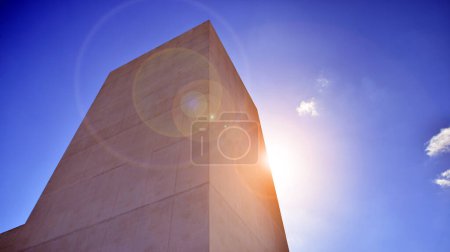 Sunlight and shadow on surface of white Concrete Building wall against blue sky background, Geometric Exterior Architecture in Minimal Street photography style