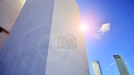 Sunlight and shadow on surface of white Concrete Building wall against blue sky background, Geometric Exterior Architecture in Minimal Street photography style