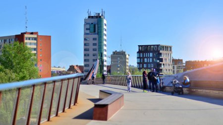 Warsaw, Poland. 11 April 2024. Bridge over the Vistula River intended only for pedestrians and cyclists. In the background, a panorama of the city on the right bank of the Vistula.