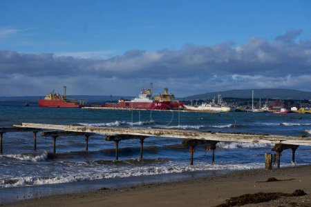 Photo for Punta Arenas, Chile - October 30, 2022: Waterfront along the Straight of Magellan in Punta Arenas, southern Chile. Ice ships docked at the pier. - Royalty Free Image