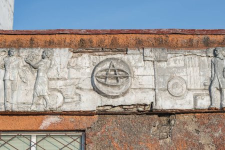 Photo for Old abandoned white bas-relief on the theme of transport on the facade of an old bus park. Kyiv, Ukraine - March 2021. - Royalty Free Image