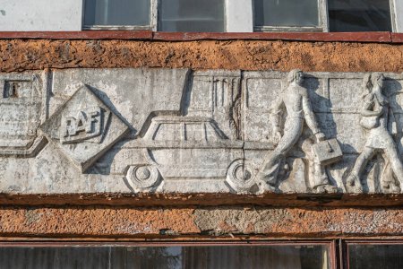 Photo for Old abandoned white bas-relief on the theme of transport with cars and pedestrians on the facade of an old bus park. Kyiv, Ukraine - March 2021. - Royalty Free Image