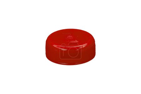 Red plastic HDPE cap from drinking water bottle isolated on a white background.