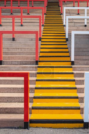 Photo for Colourful pattern composed of steps and safety barriers on the terraces of an English soccer stadium - Royalty Free Image