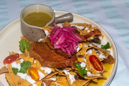 Typical mexican chilaquiles with yucatecan pork