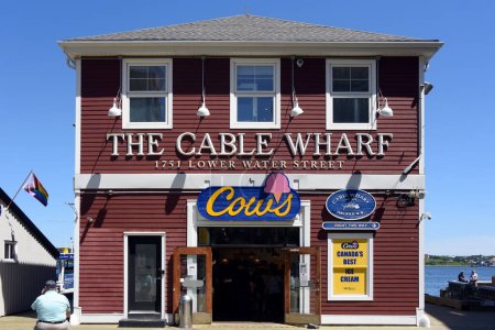 Photo for Halifax, Canada - August 2, 2023: Cable Wharf restaurant and Cows ice cream parlor on the Halifax Waterfront. Cows is a Canadian ice cream manufacturer and chain of ice cream parlors based in Prince Edward Island, another Maritime province. - Royalty Free Image