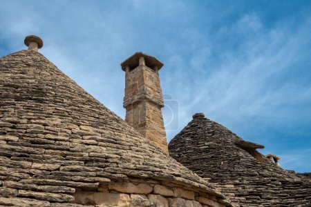 Photo for Stone roofs with a brick chimney - Royalty Free Image