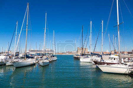 Photo for Marina bay with yachts, vessels, sailboats and other ships in Livorno, Italy. Sunny day with blue sky and sea water - Royalty Free Image