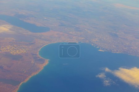 Photo for View from the airplane vindow to sea bay with small town - Royalty Free Image