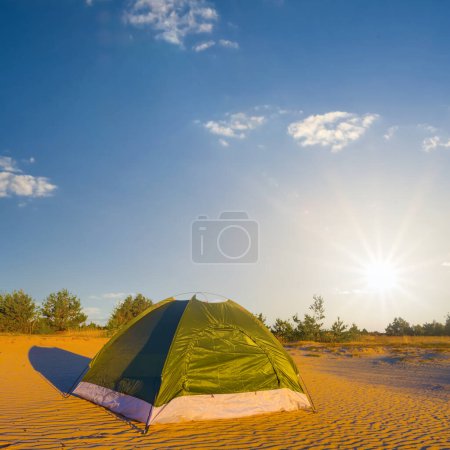 Photo for Small green touristic tent  stay among sandy desert at the sunset - Royalty Free Image