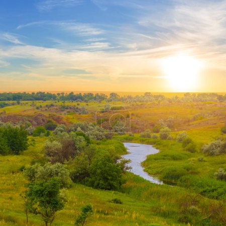 Photo for Small river among green prairie at the sunset - Royalty Free Image