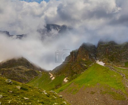 Photo for Green mountain ridge in mist and dense clouds - Royalty Free Image