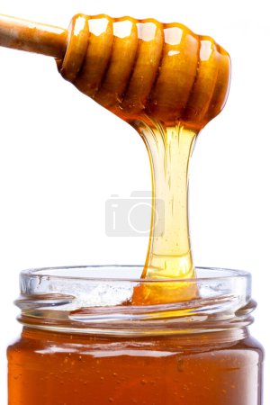 Photo for Jar of honey and honey spoon - Royalty Free Image