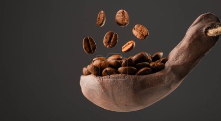 Photo for Ceramic spoonful of coffee beans - Royalty Free Image