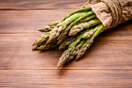 Fresh green asparagus on the wooden background