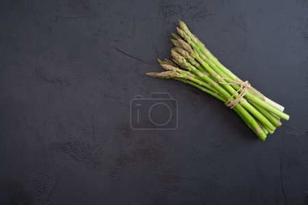 Fresh green asparagus on the black background