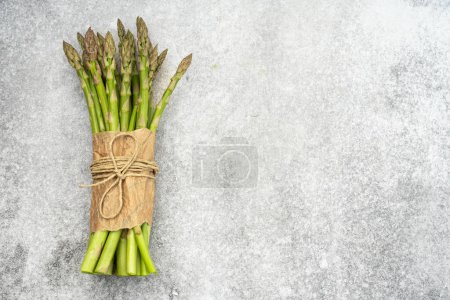 Fresh green asparagus on the vintage background