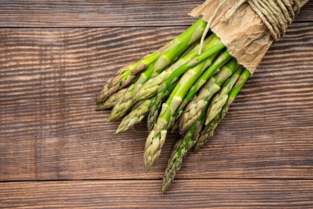Fresh green asparagus on the wooden background