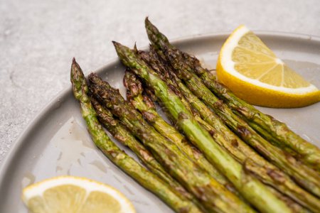 Fresh green asparagus on the grey stone background