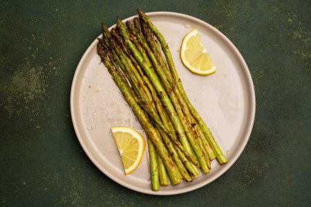 Fresh green asparagus on the green  stone background