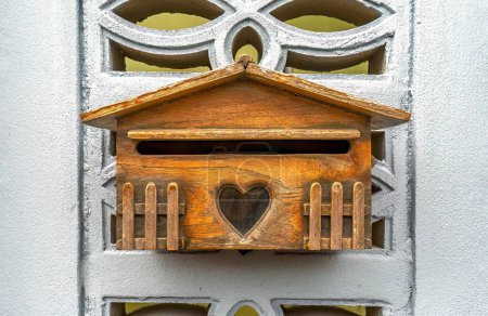 Foto de Beautiful mini wooden house mailboxes hung on a concrete block wall, with a background isolated and clipping path. - Imagen libre de derechos