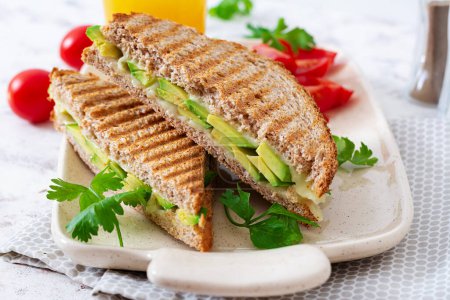Foto de Vegan sandwich with cheese and avocado. Vegetarian breakfast. - Imagen libre de derechos
