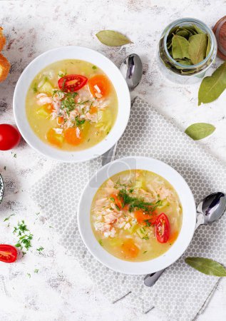 Photo for Fish soup with salmon, vegetables and rice in white bowl. Top view, above - Royalty Free Image