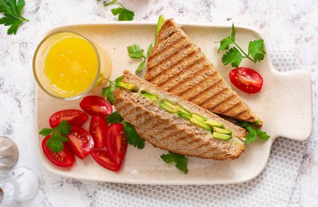 Foto de Vegan sandwich with cheese and avocado. Vegetarian breakfast. Top view, flat lay - Imagen libre de derechos