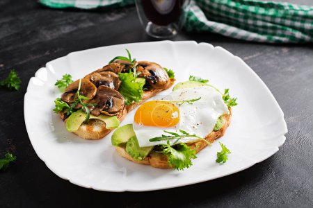 Photo for Sandwiches  with avocado, fried egg and mushrooms  for healthy breakfast or snack. - Royalty Free Image