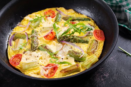 Photo for Healthy asparagus omelette. Eggs omelet with asparagus, tomatoes, and cheese. - Royalty Free Image