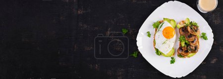 Photo for Sandwiches  with avocado, fried egg and mushrooms  for healthy breakfast or snack. Top view, banner - Royalty Free Image