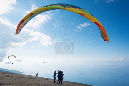 Photo for Babadag. Paragliding start in the air with blue sky, green hills and mountains background near Oludeniz in Turkey - Royalty Free Image