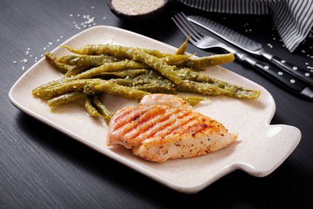 Photo for Chicken fillet cooked on a grill and garnish of green beans. - Royalty Free Image