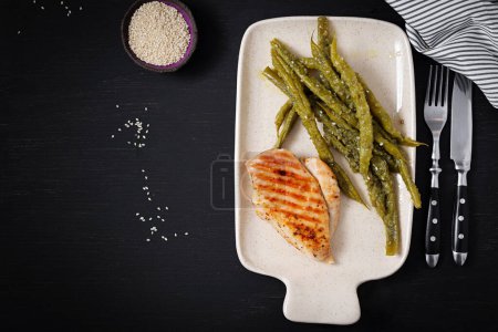 Photo for Chicken fillet cooked on a grill and garnish of green beans. Top view - Royalty Free Image