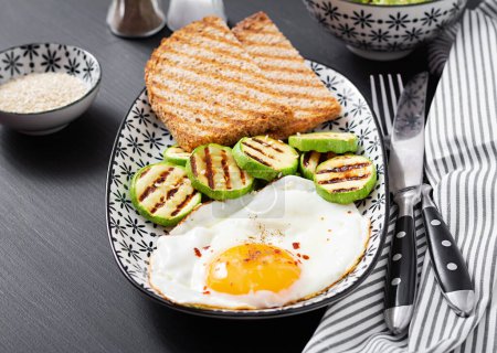 Photo for Breakfast. Toast with avocado guacamole, grilled zucchini and fried egg.  Brunch. - Royalty Free Image