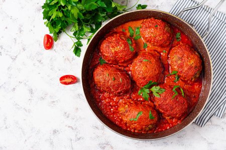 Photo for Lazy cabbage rolls stewed in sweet and sour tomato sauce. Meatballs. Beef cutlet. Top view - Royalty Free Image