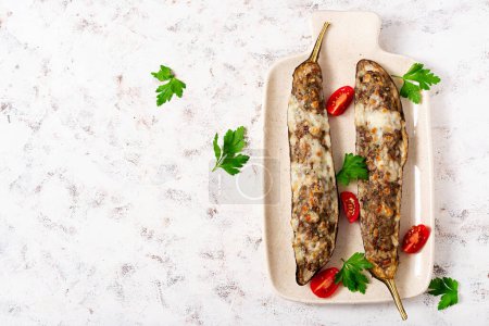 Photo for Stuffed eggplant with beef meat, vegetable and cheese. Top view, overhead - Royalty Free Image