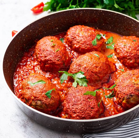 Lazy cabbage rolls stewed in sweet and sour tomato sauce. Meatballs. Beef cutlet.