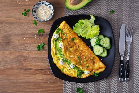 Omelette with mozzarella cheese and avocado. Ketogenic, keto diet breakfast. Top view, copy space
