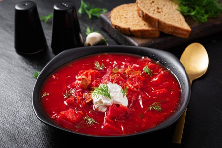 Photo for Traditional Ukrainian borscht. Bowl of red beetroot soup borsch with white cream. Beet root delicious soup. Ukrainian food. - Royalty Free Image