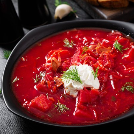 Foto de Traditional Ukrainian borscht. Bowl of red beetroot soup borsch with white cream. Beet root delicious soup. Ukrainian food. - Imagen libre de derechos
