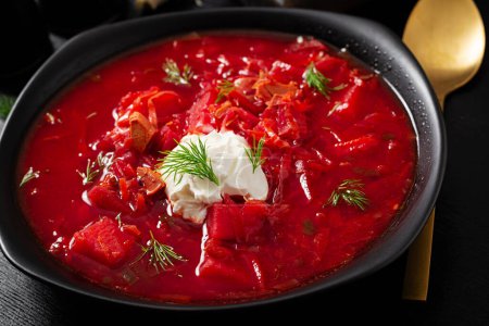 Photo for Traditional Ukrainian borscht. Bowl of red beetroot soup borsch with white cream. Beet root delicious soup. Ukrainian food. - Royalty Free Image
