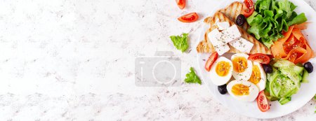 Photo for Healthy breakfast. Salad with feta cheese, eggs, cucumber and carrot. Healthy balanced food. Top view, banner - Royalty Free Image
