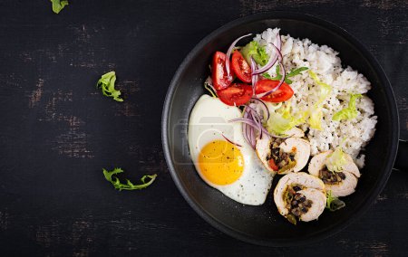 Photo for Fried egg, meat chicken roll, rice and tomatoes. Paleo breakfast. Top view, overhead - Royalty Free Image