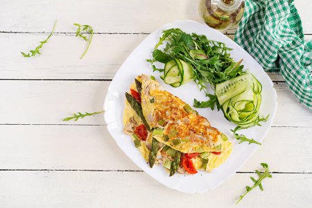 Photo for Keto breakfast. Omelette with chicken fillet, tomatoes and asparagus on white wooden table. Italian frittata. Keto, ketogenic lunch. Top view, overhead, copy space - Royalty Free Image