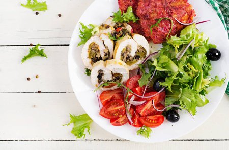 Photo for Ketogenic breakfast. Chicken roll stuffed with mushrooms, beetroot fritters and fresh vegetable salad. Keto, ketogenic lunch. Top view, flat lay - Royalty Free Image